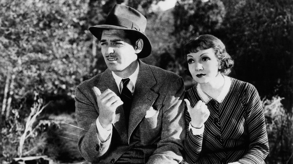 A screenshot from It Happened One Night with Clark Gable and Claudette Colbert during the hitchhike scene.