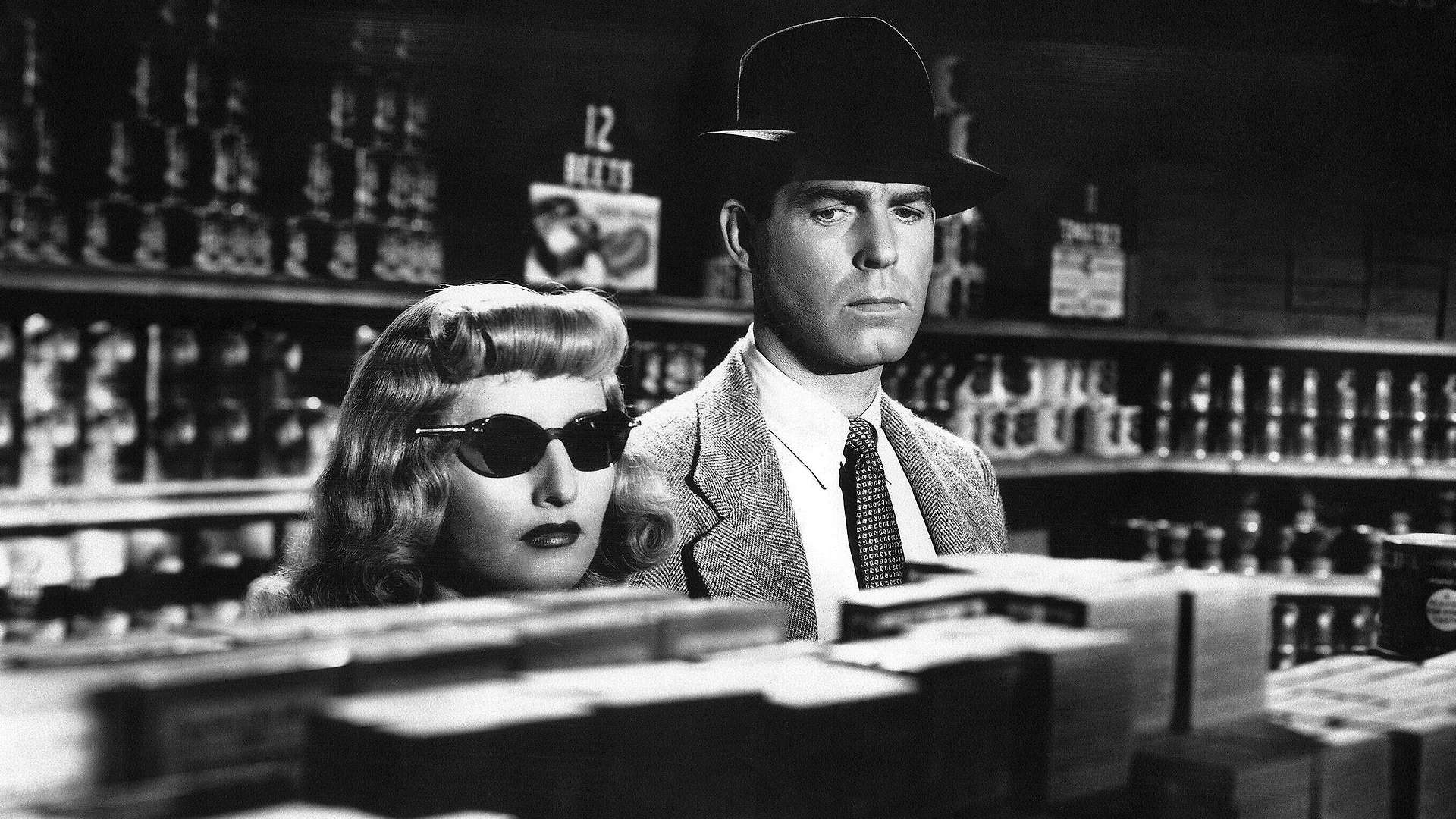 A screenshot from Double Indemnity. Walter Neff and Phyllis Dietrichson talking privately in the back of a grocery store.