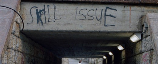 A frame from the movie Skill Issue (2024). The bridge has a graffiti on it. It says Skill Issue.